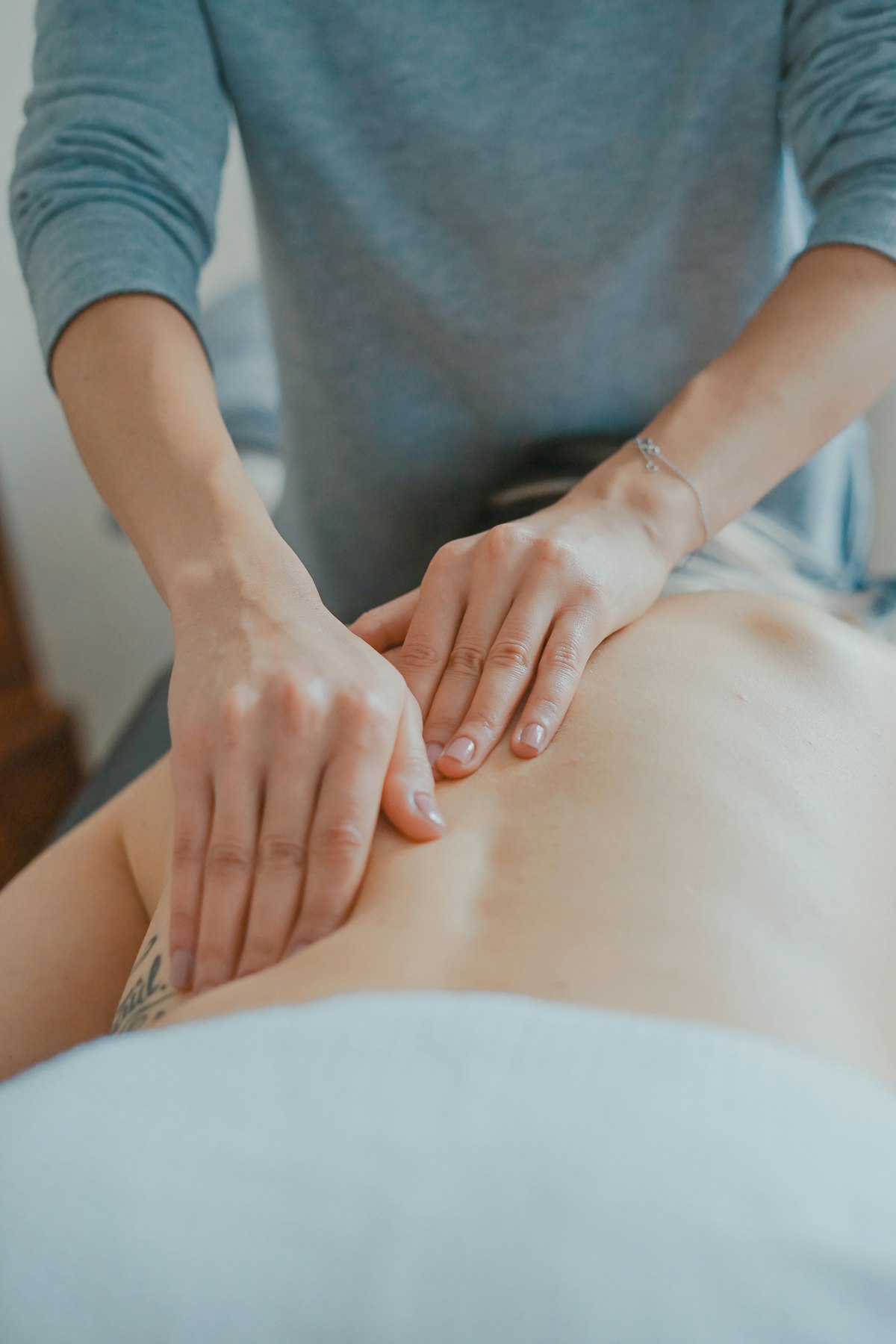 Therapist's hands performing a massage treatment